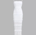 a white dress with fringes on the bottom