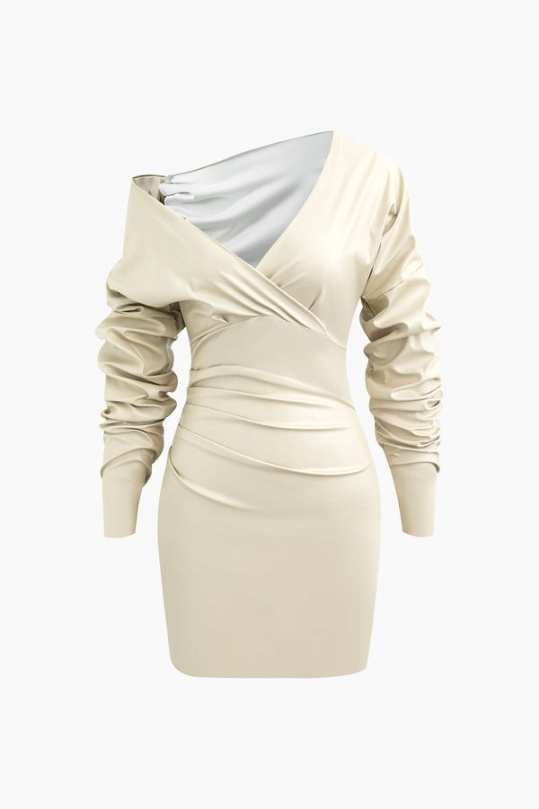 a white dress with long sleeves and a silver shoulder