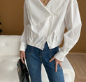 a woman wearing a white shirt and jeans