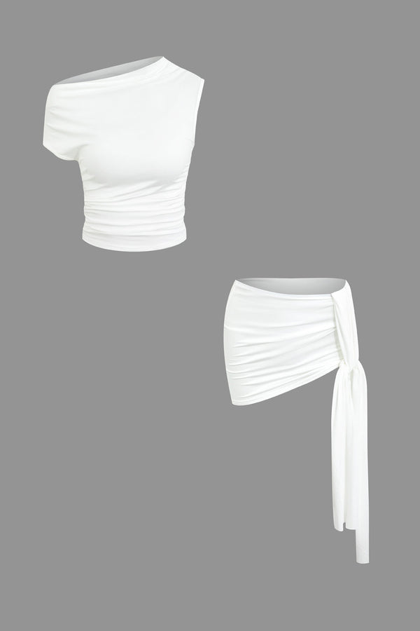 a white crop top with a tie around the waist