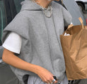 a woman is carrying a brown paper bag