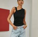 a woman in a black top and jeans