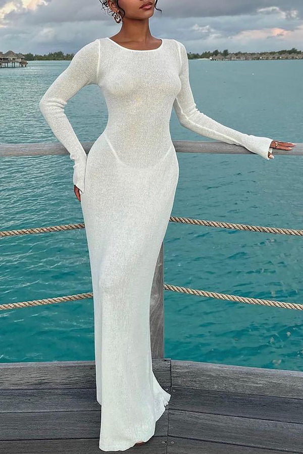 a woman in a white dress standing on a dock