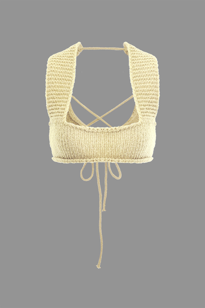 a white knitted top with a tie around the neck