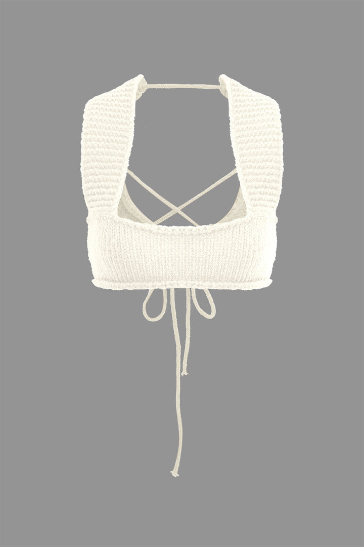 a white knitted top with a tie around the neck