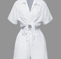 a woman is wearing a white shirt and shorts
