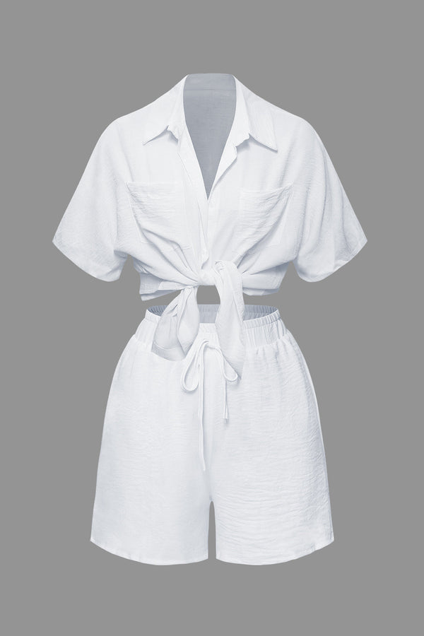 a woman is wearing a white shirt and shorts