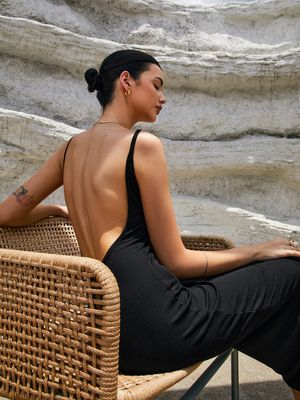 a woman sitting on a wicker