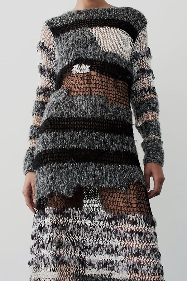 a woman in a black and white knit dress