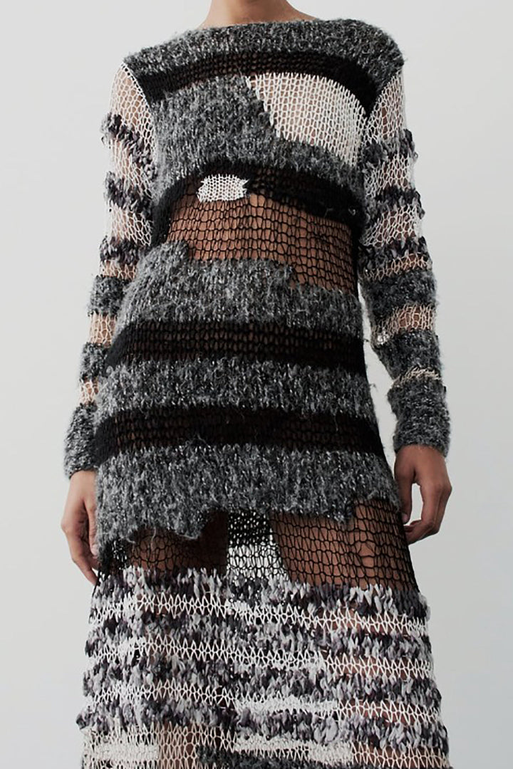 a woman in a black and white knit dress