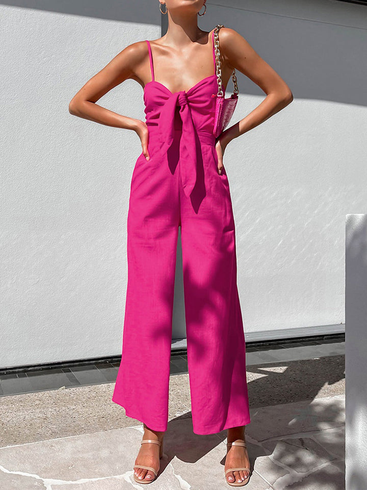 a woman wearing a pink jumpsuit