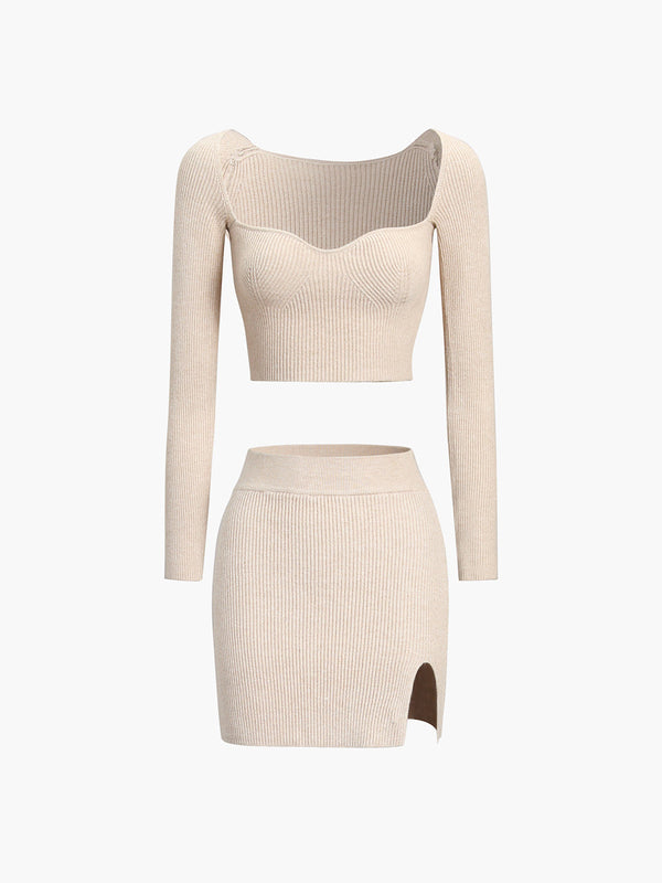 a woman in a beige sweater and skirt