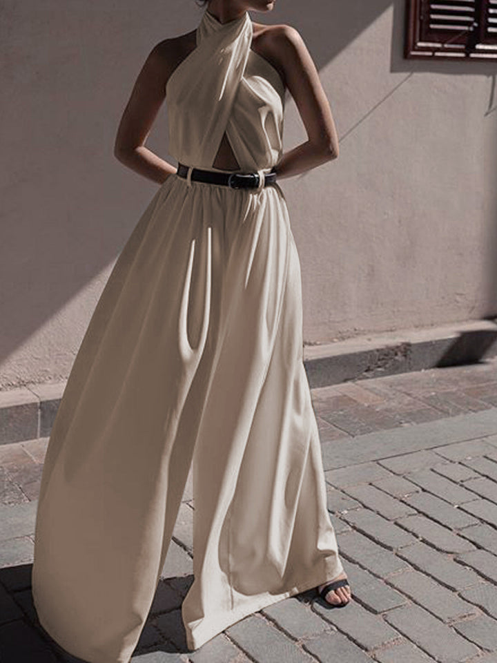 a woman in a white dress standing on a sidewalk