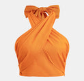 a woman wearing an orange top with a bow