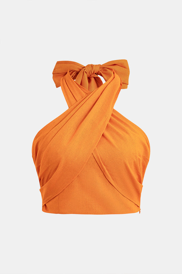 a woman wearing an orange top with a bow
