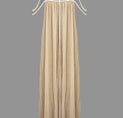 a woman wearing a beige dress with spaghetti straps
