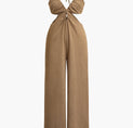 a woman is wearing a tan jumpsuit