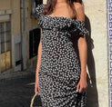 a woman wearing a black and white floral print dress