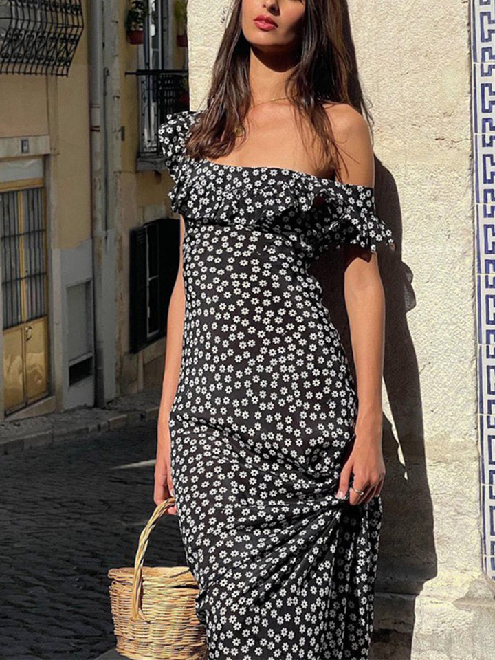 a woman wearing a black and white floral print dress