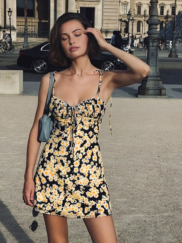 a woman in a black and yellow floral dress