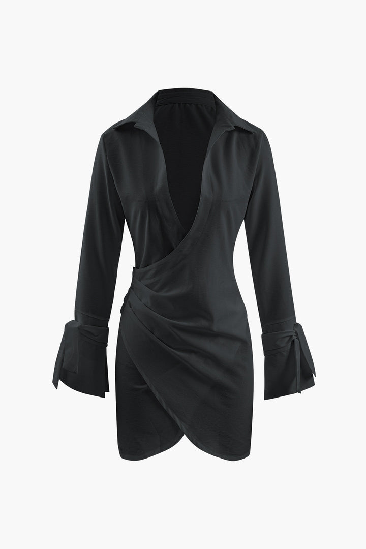 a woman wearing a black dress with long sleeves