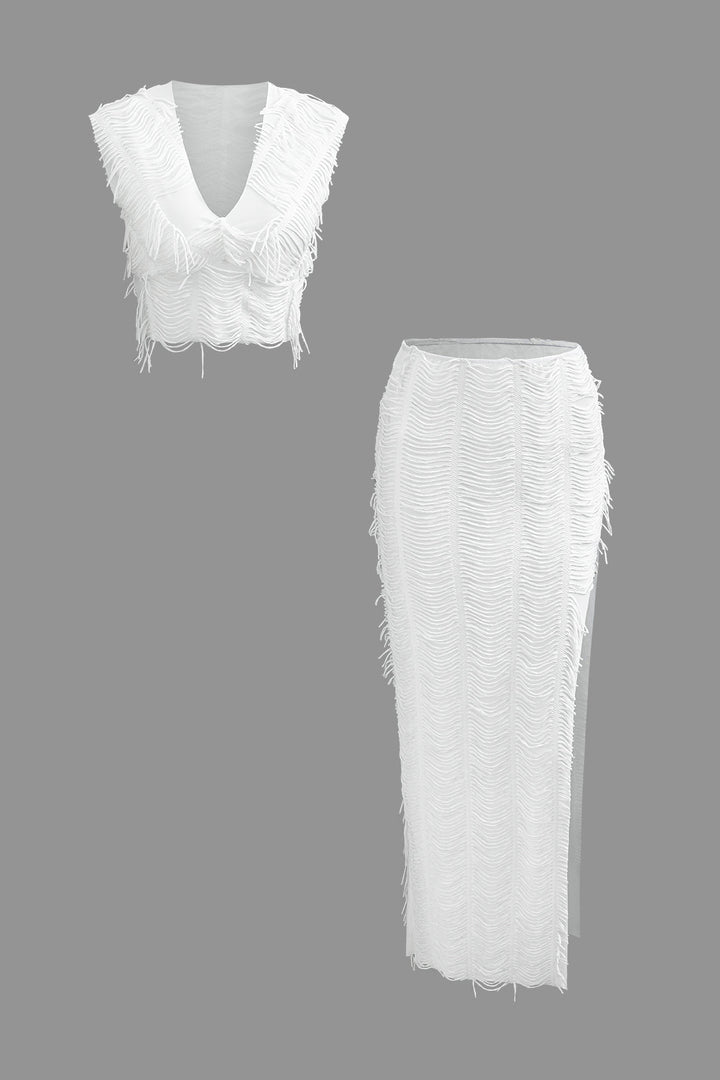 a white top and skirt with fringes