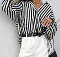 a woman wearing a black and white striped shirt