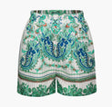 a white shorts with green and blue floral print