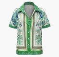 a green and white shirt with paisley print