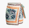 a white and blue floral print skirt with orange trim