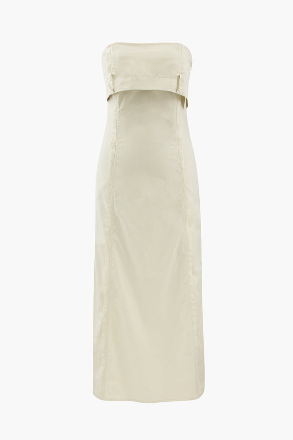 a woman wearing a white dress with a belt