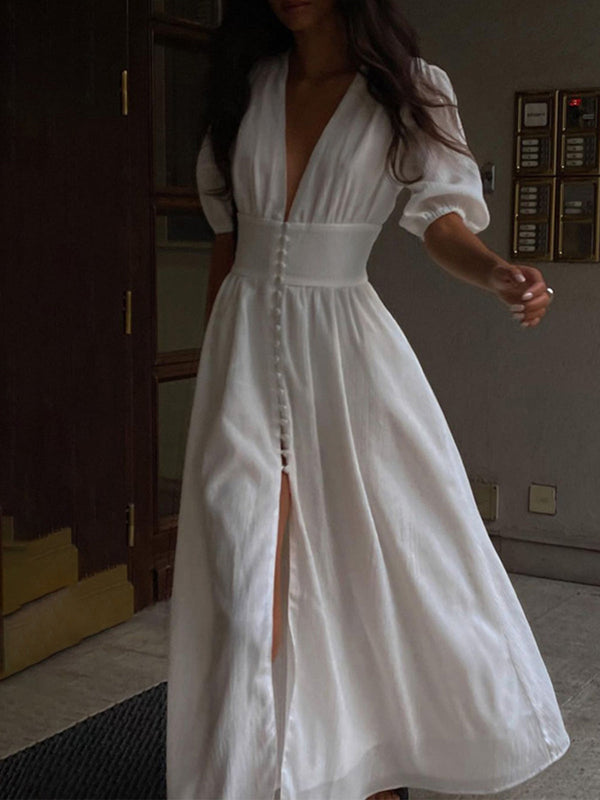 a woman in a white dress is standing on the floor
