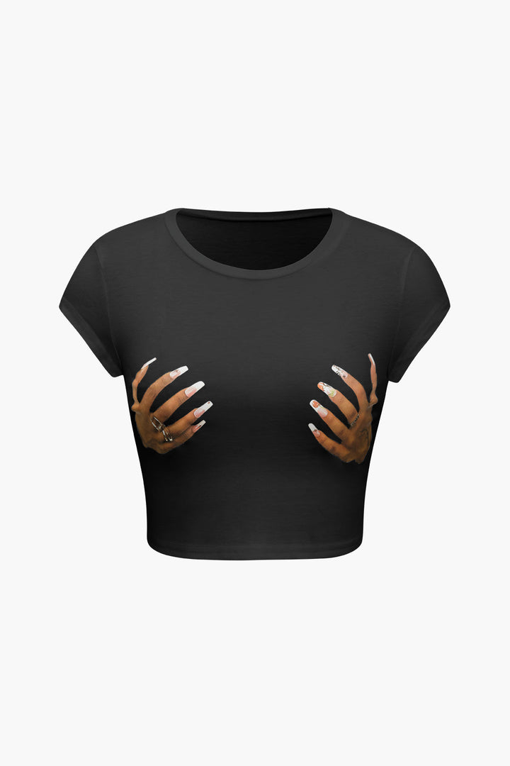 a woman ' s crop top with her hands on her chest