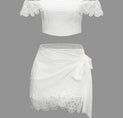 a white top and skirt with lace detailing