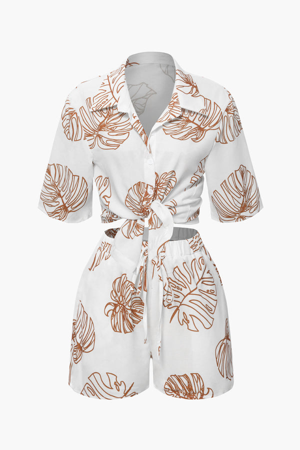 a white shirt and shorts with orange leaves on it