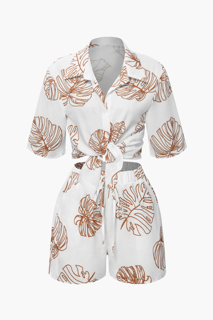 a white shirt and shorts with orange leaves on it