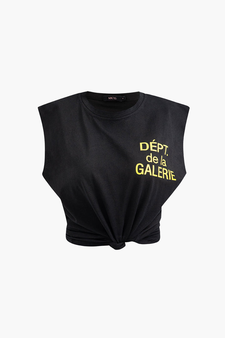 a black crop top with a yellow logo on the front