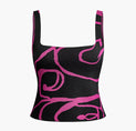 a black and pink crop top with pink swirl print