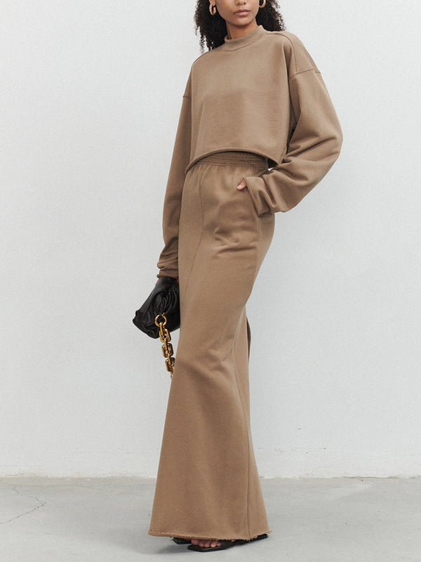 a woman standing in front of a white wall