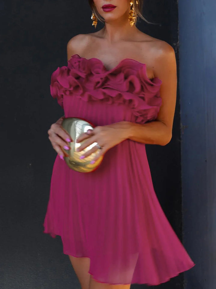 a woman in a pink dress holding a gold clutch