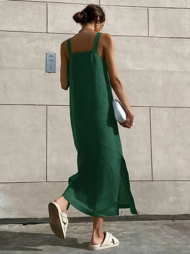 a woman in a green dress walking down the street