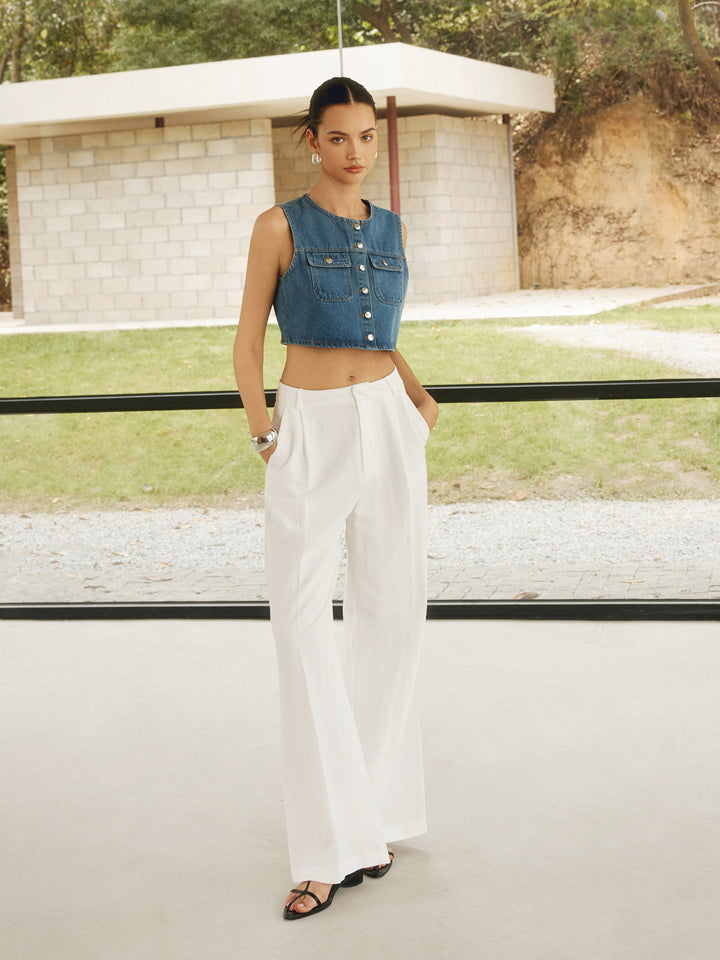 a woman in a blue top and white pants