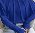 a woman wearing a blue turtle neck sweater