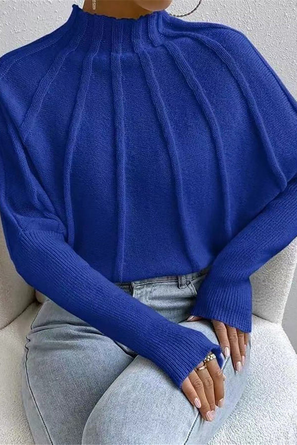 a woman wearing a blue turtle neck sweater