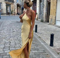 a woman in a yellow dress walking down the street