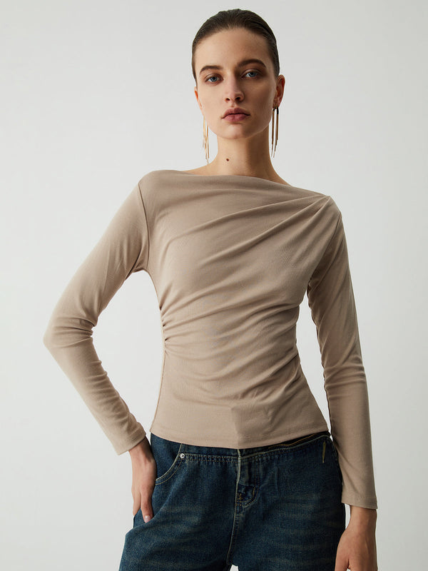 a woman in a tan sweater and jeans