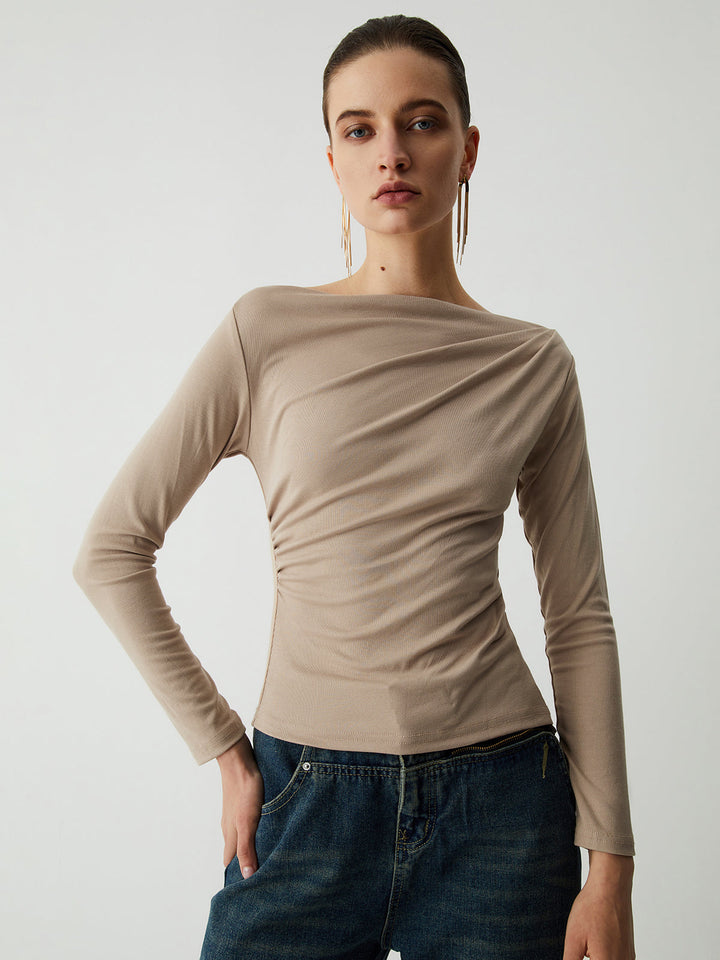 a woman in a tan sweater and jeans