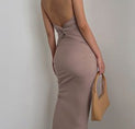 the back of a woman in a beige dress