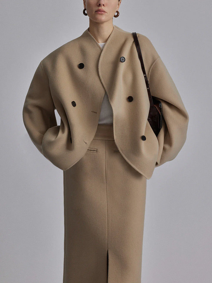 a woman in a beige coat and skirt