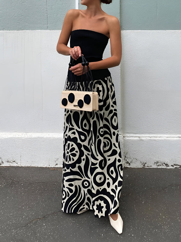 a woman standing in front of a white wall